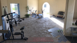 Open-air fitness center at the Cabo San Lucas beachfront resort, with weight machines and cardio equipment.